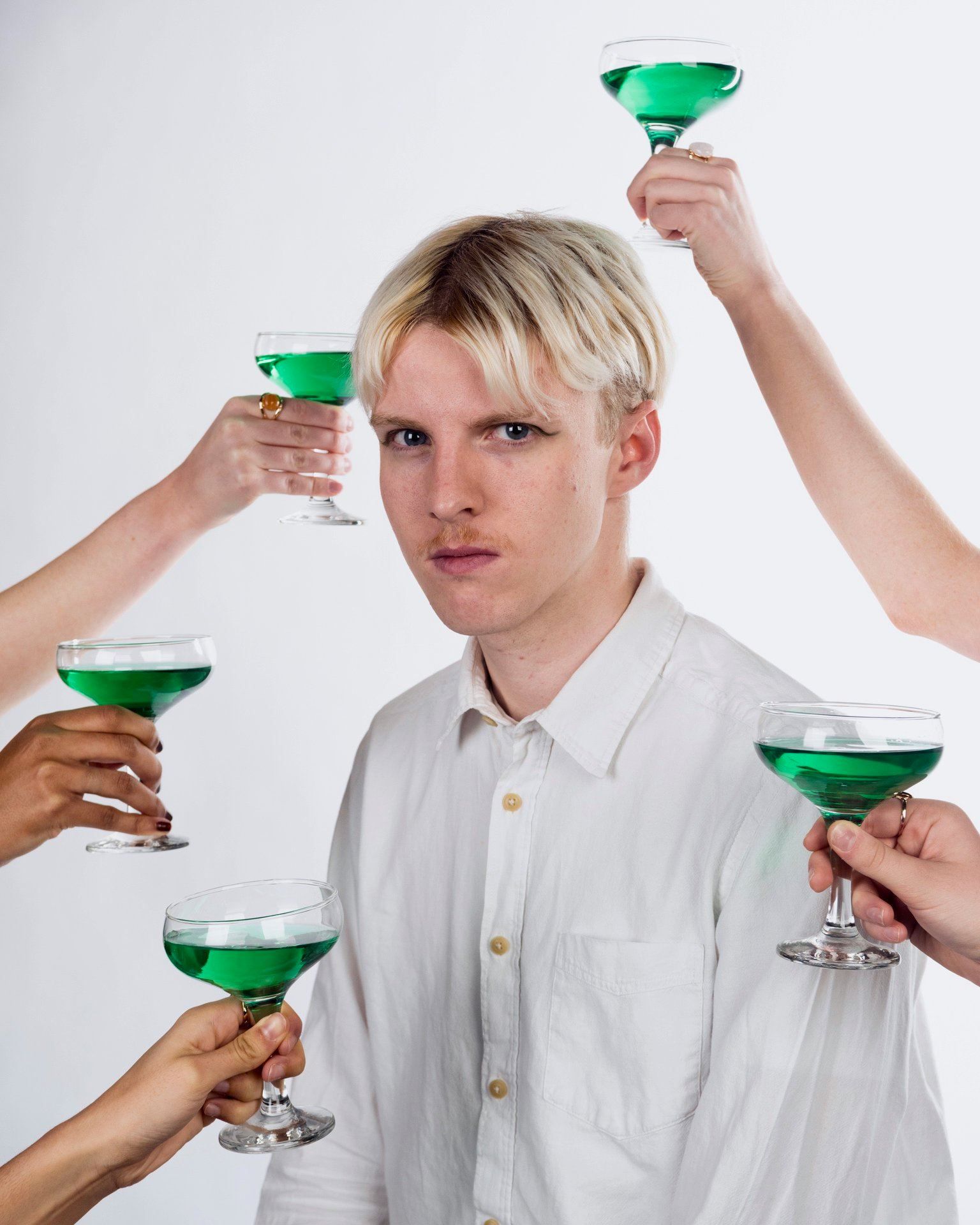 Image may contain: Finger, Clothing, Apparel, Alcohol, Cocktail, Beverage, Drink, Goblet, Glass, Person, Human