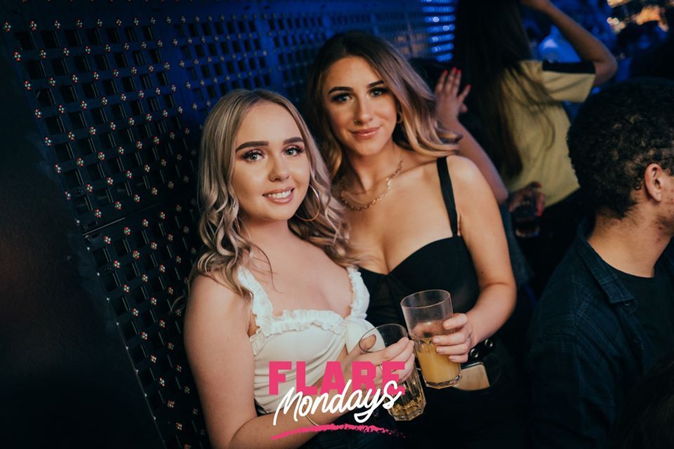 Image may contain: Glass, Alcohol, Night Club, Night Life, Drink, Beverage, Club, Person, Human