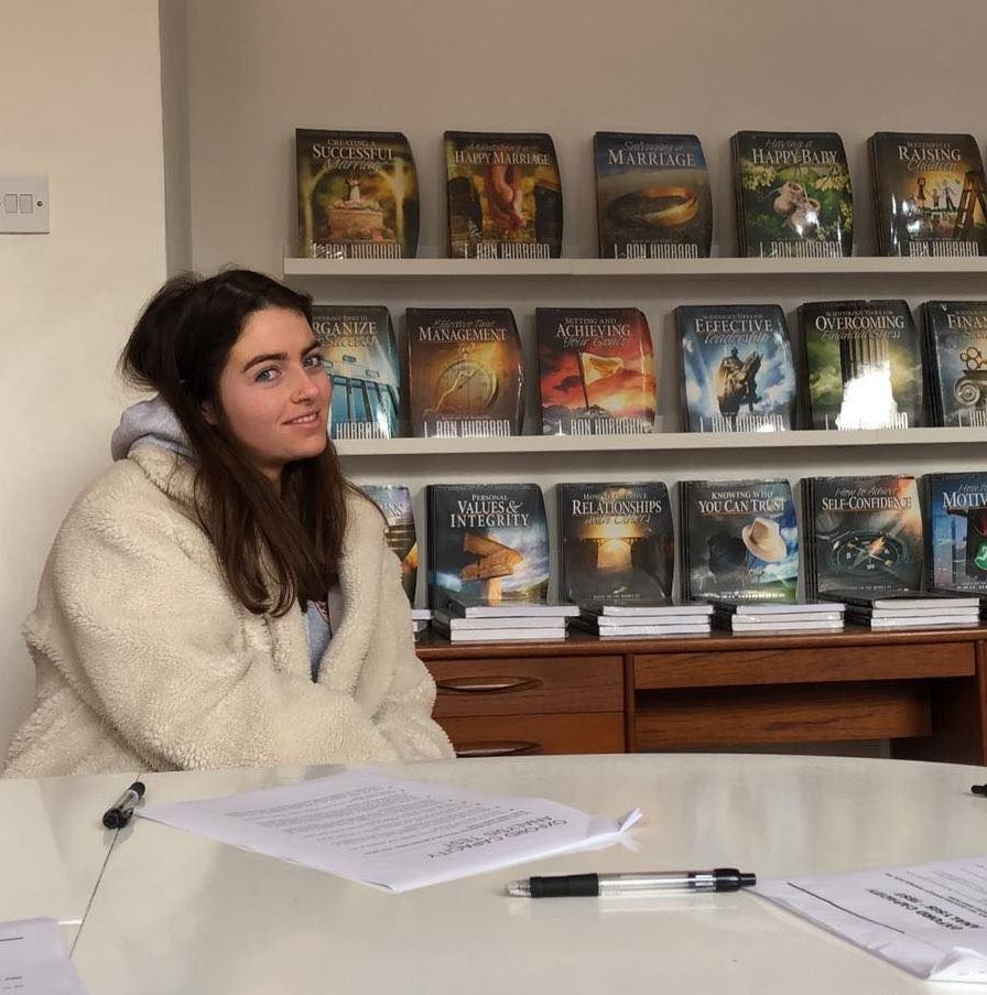 Image may contain: Library, Room, Indoors, Desk, Table, Bookcase, Human, Person, Furniture, Shelf, Book
