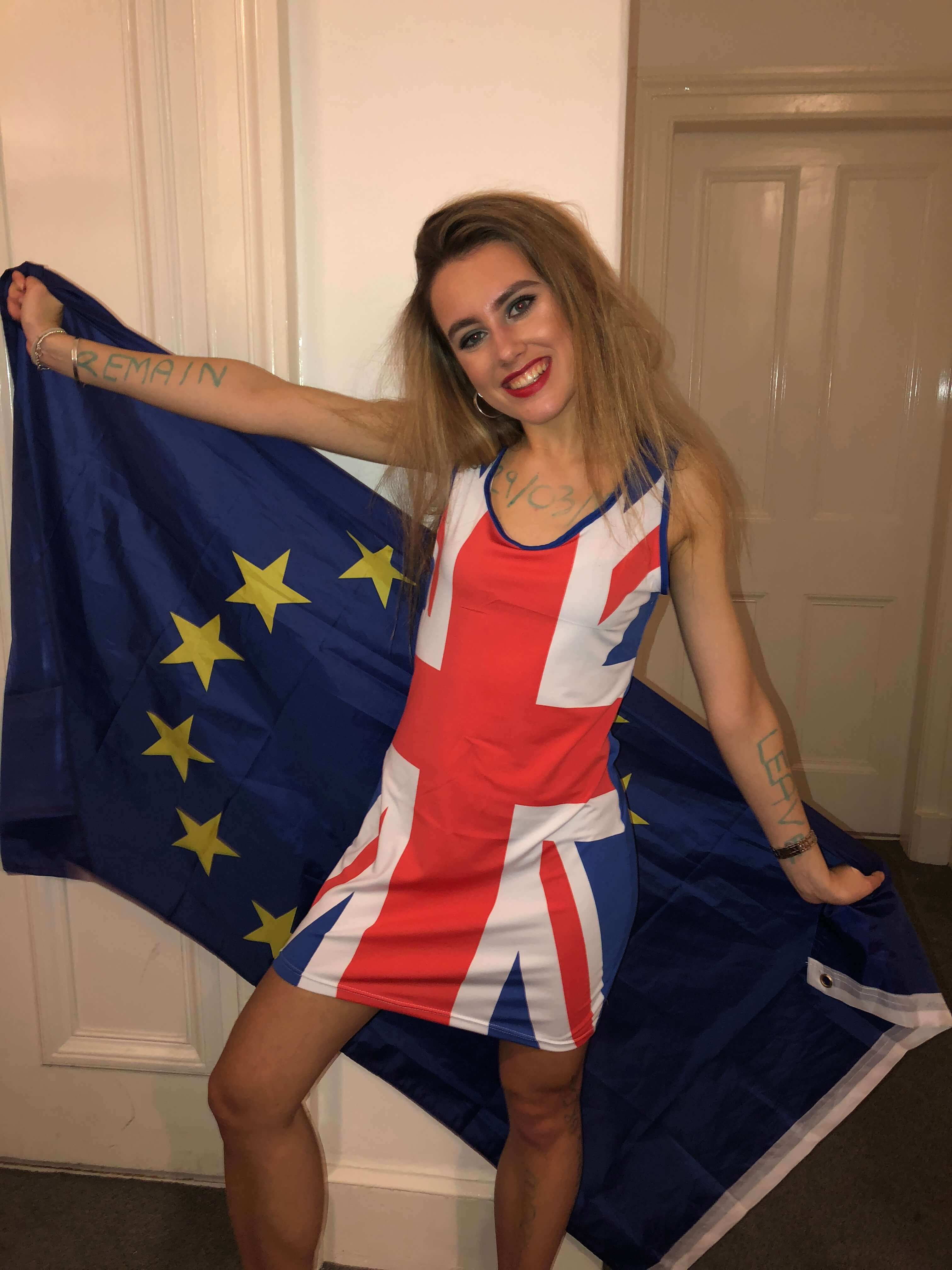 Image may contain: Wood, Flag, Symbol, Apparel, Clothing, Human, Person