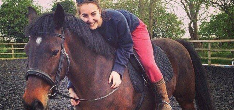 A Surrey girl relaxes on her horse