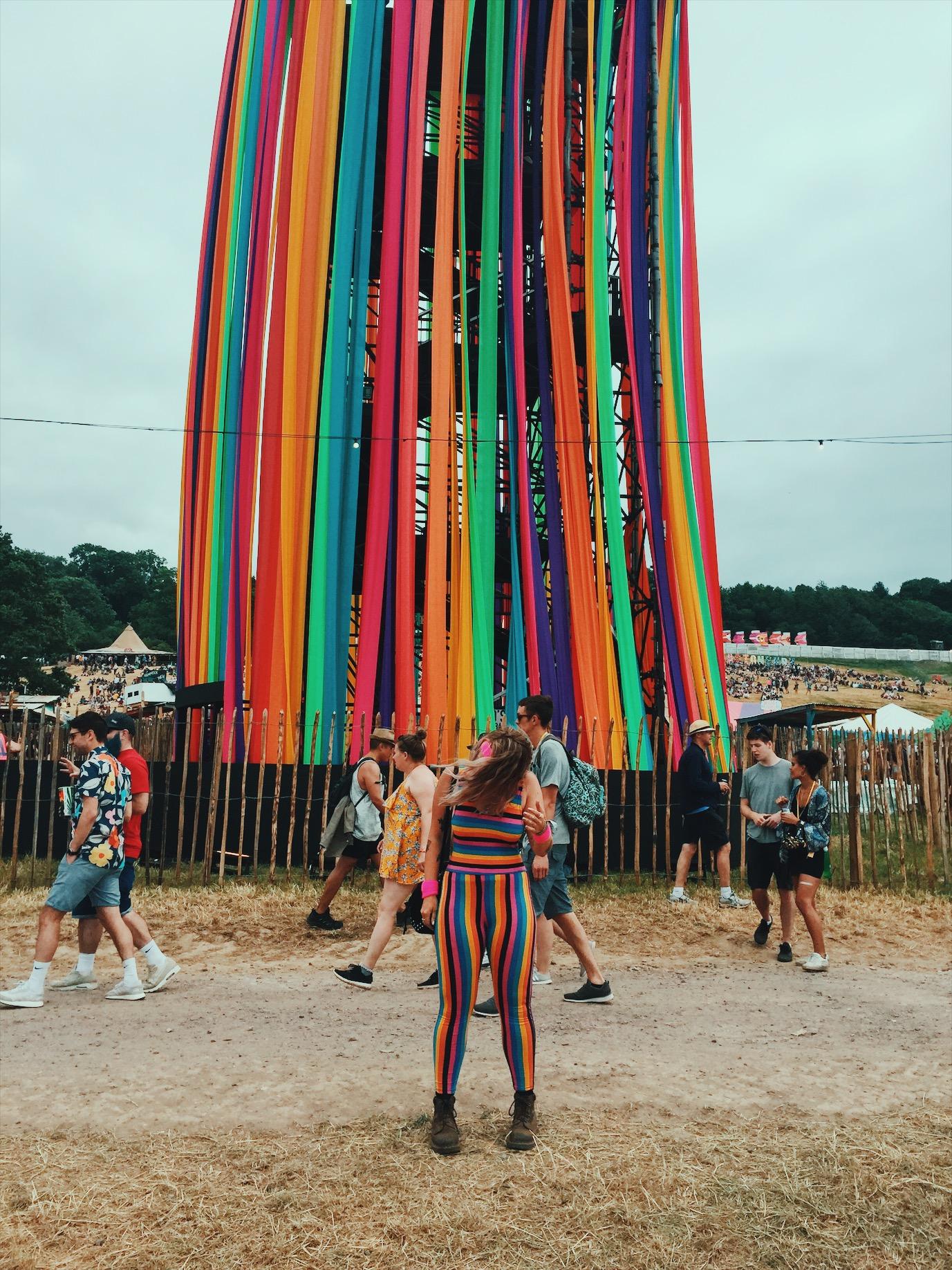 Matching her surroundings, Emmy's rainbow jumpsuit fits in perfectly