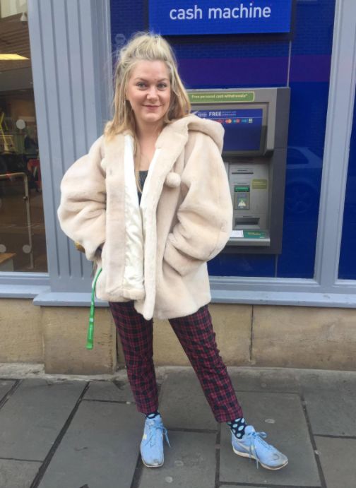 Image may contain: Coat, Clothing, Woman, Girl, Female, Blonde, Machine, Cash Machine, Atm, Person, People, Human