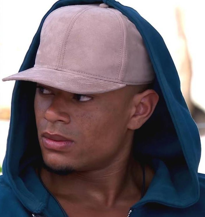 Image may contain: Hat, Clothing, Cap, Beanie, Portrait, Face, Person, People, Human
