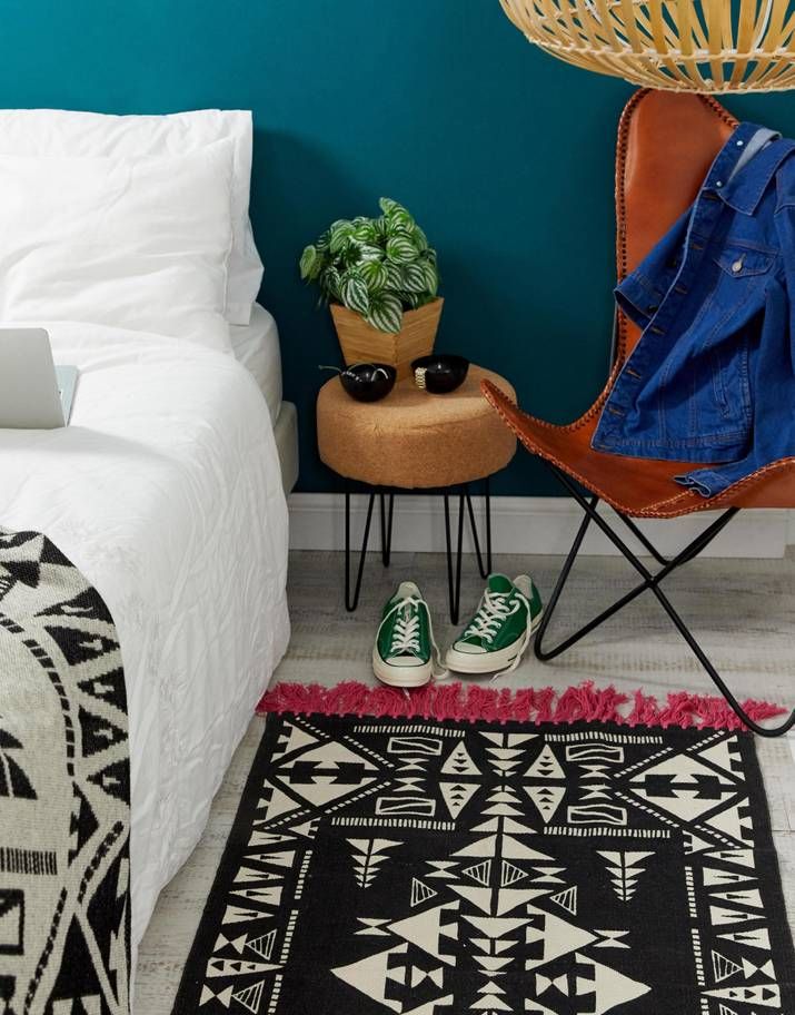 Image may contain: Apparel, Shoe, Footwear, Clothing, Vase, Pottery, Jar, Potted Plant, Bed, Person, Human, Plant, Rug, Furniture