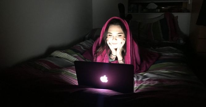 Image may contain: Millennial burnout symptoms, Millennial burnout, netflix, Couch, Person, Human, Bed, Furniture, Laptop, Electronics, Pc, Computer