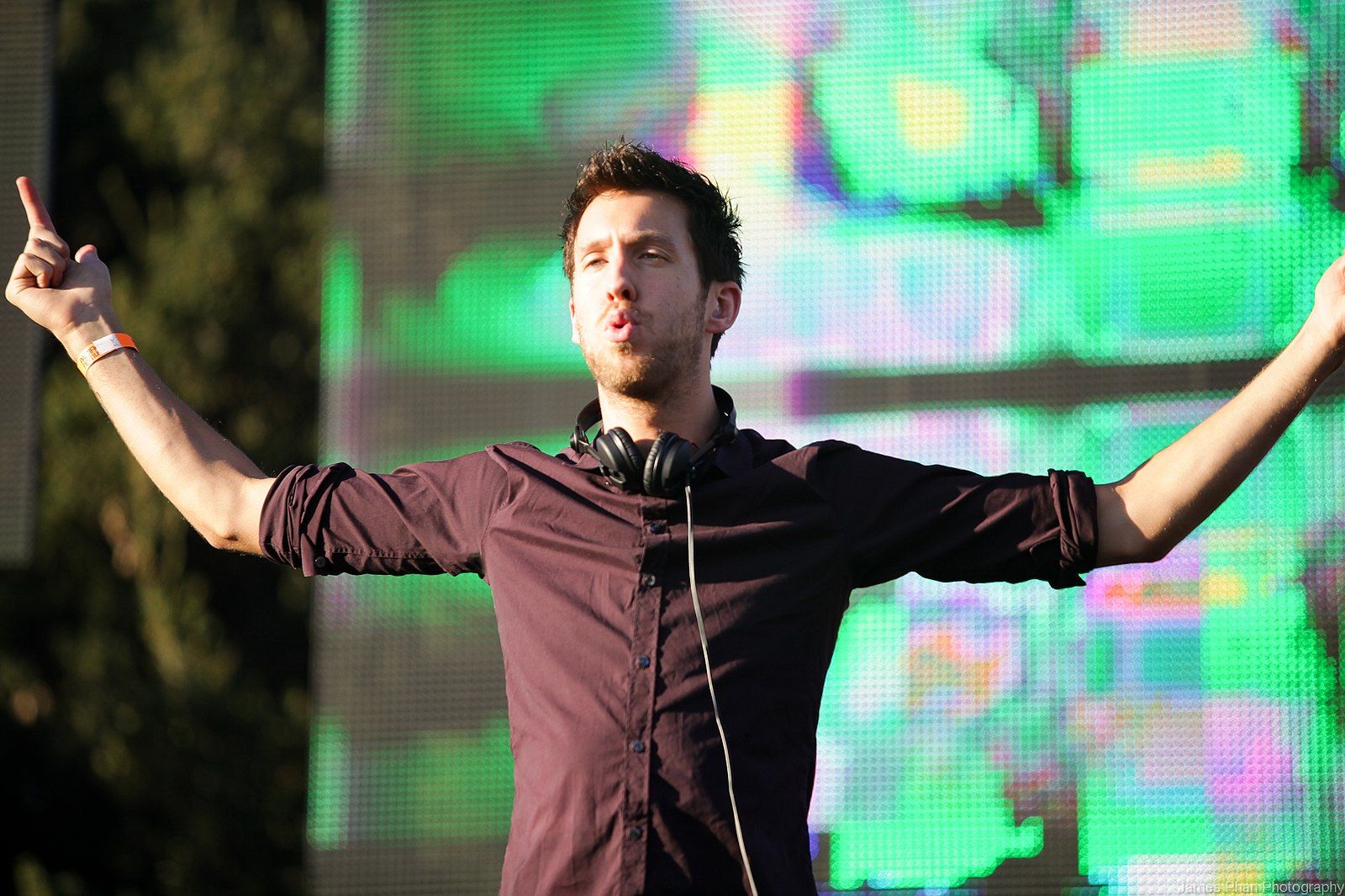 Image may contain: Calvin Harris transformation, Calvin Harris, 2011, Crowd, Apparel, Sleeve, Clothing, Finger, Person, Human