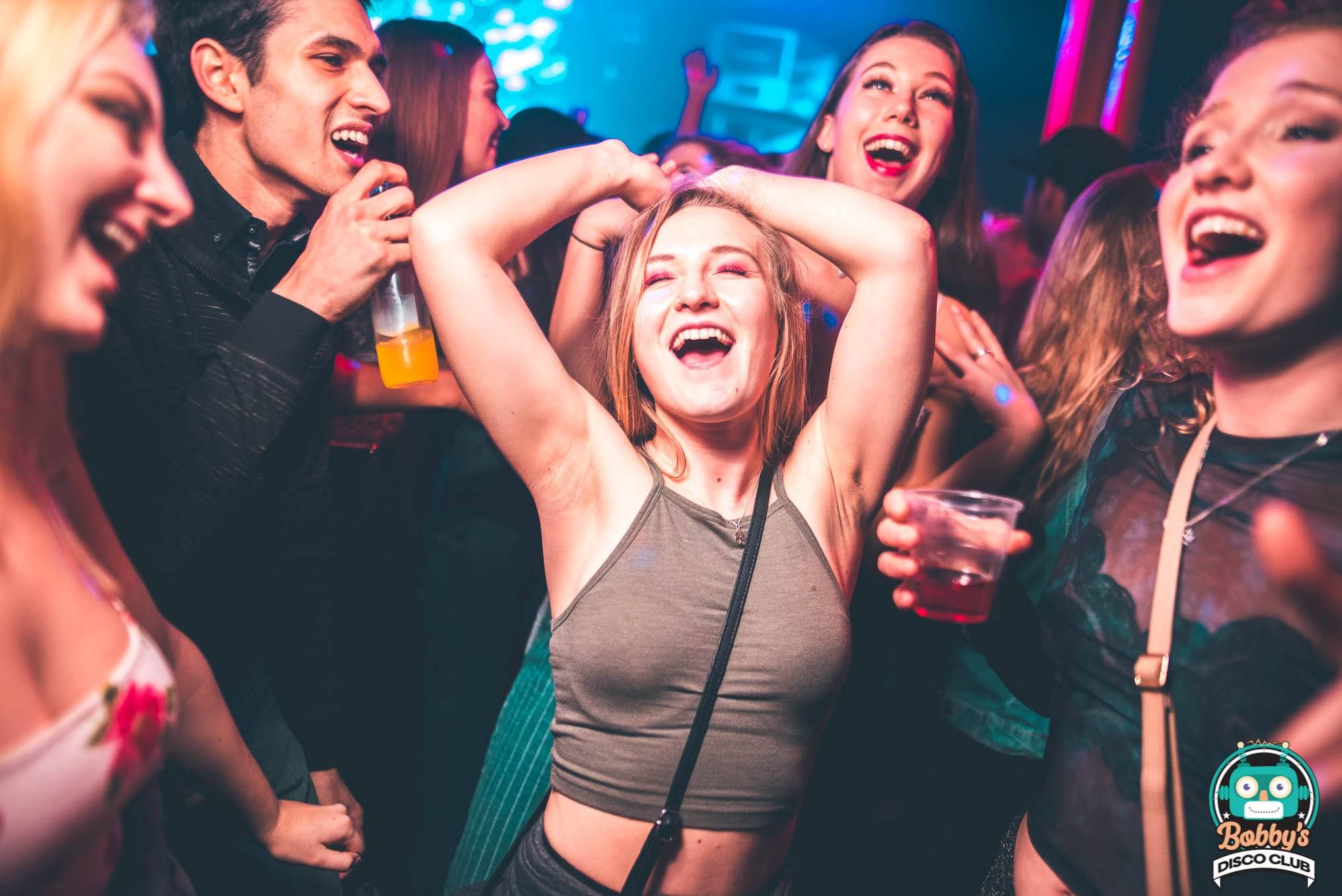 Image may contain: Disco, Night Life, Beverage, Drink, Beer, Alcohol, Night Club, Club, Person, Human, Party