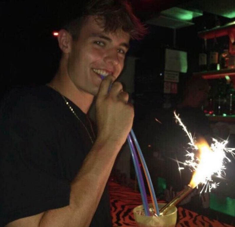 Image may contain: Bar Counter, Alcohol, Cocktail, Pub, Fire, Bonfire, Flame, Beverage, Drink, Night Club, Club, Human, Person