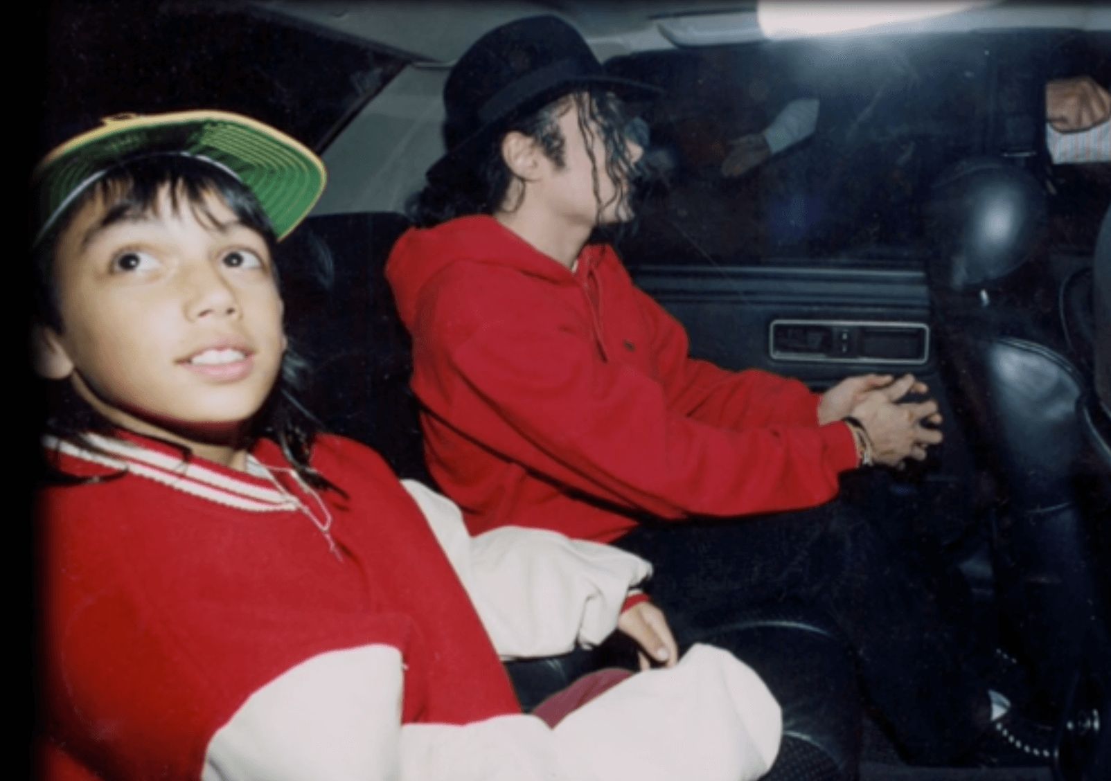 Image may contain: Michael Jackson and Macaulay Culkin, Michael Jackson, Brett Barnes, Leaving Neverland, Car Trunk, Hat, Apparel, Clothing, Human, Person