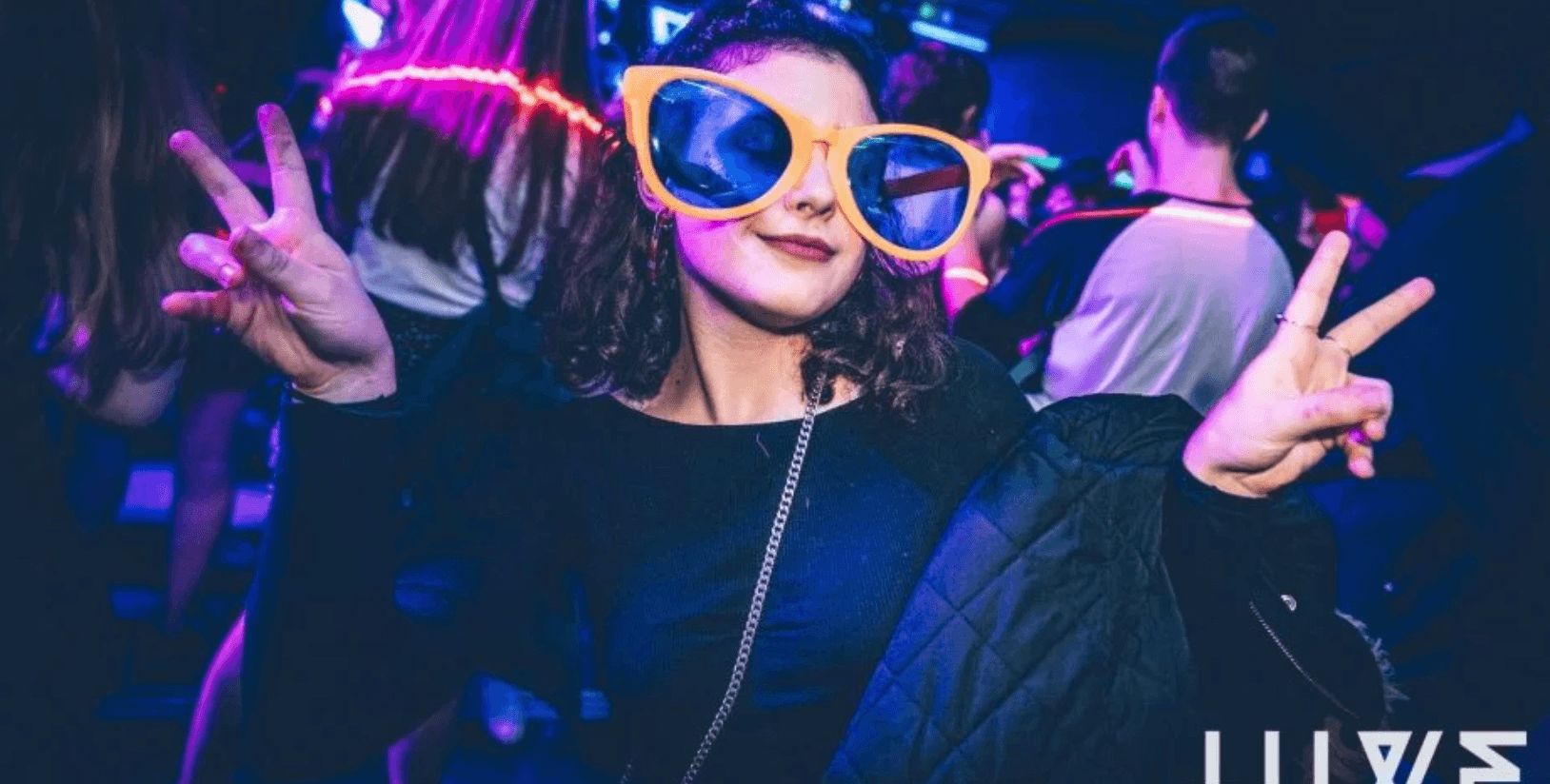 Image may contain: April Fool's Day 2019, fake news, April Fool's, prank, Purple, Crowd, Face, Night Club, Party, Glasses, Club, Night Life, Person, Human, Accessories, Sunglasses, Accessory