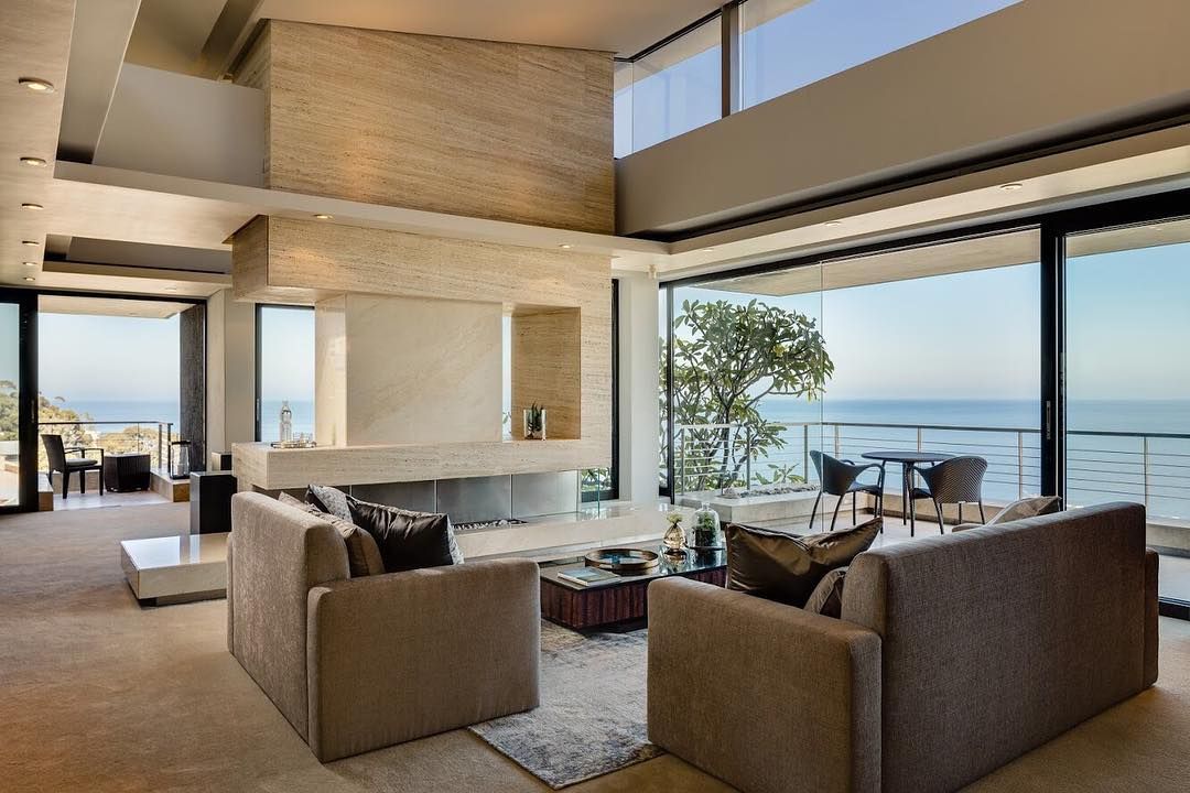Image may contain: Moondance Villa, Made in Chelsea, Cape Town, South Africa, Rug, Chair, Wood, Lobby, Tabletop, Couch, Room, Living Room, Coffee Table, Indoors, Building, Housing, Table, Furniture
