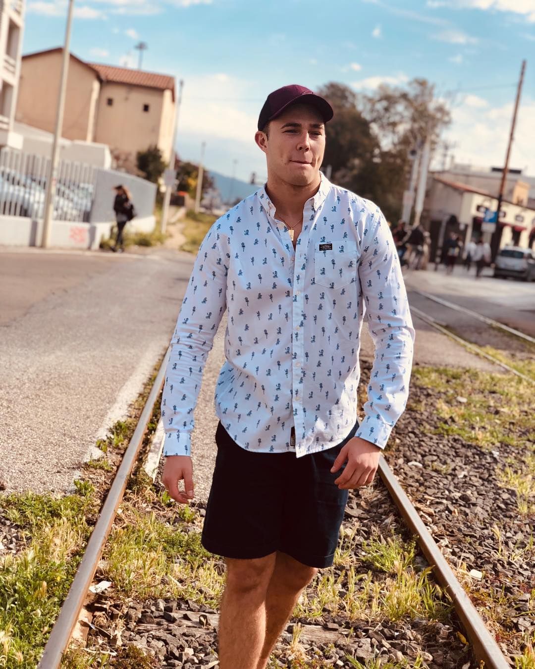 Image may contain: Love Island 2019 Instagrams, Curtis Pritchard, Love Island, 2019, followers, Instagram, contestant, social media, cast list, line up, Shirt, Long Sleeve, Rail, Train Track, Railway, Shorts, City, Street, Town, Urban, Building, Gravel, Dirt Road, Vehicle, Automobile, Transportation, Car, Sleeve, Road, Human, Person, Apparel, Clothing