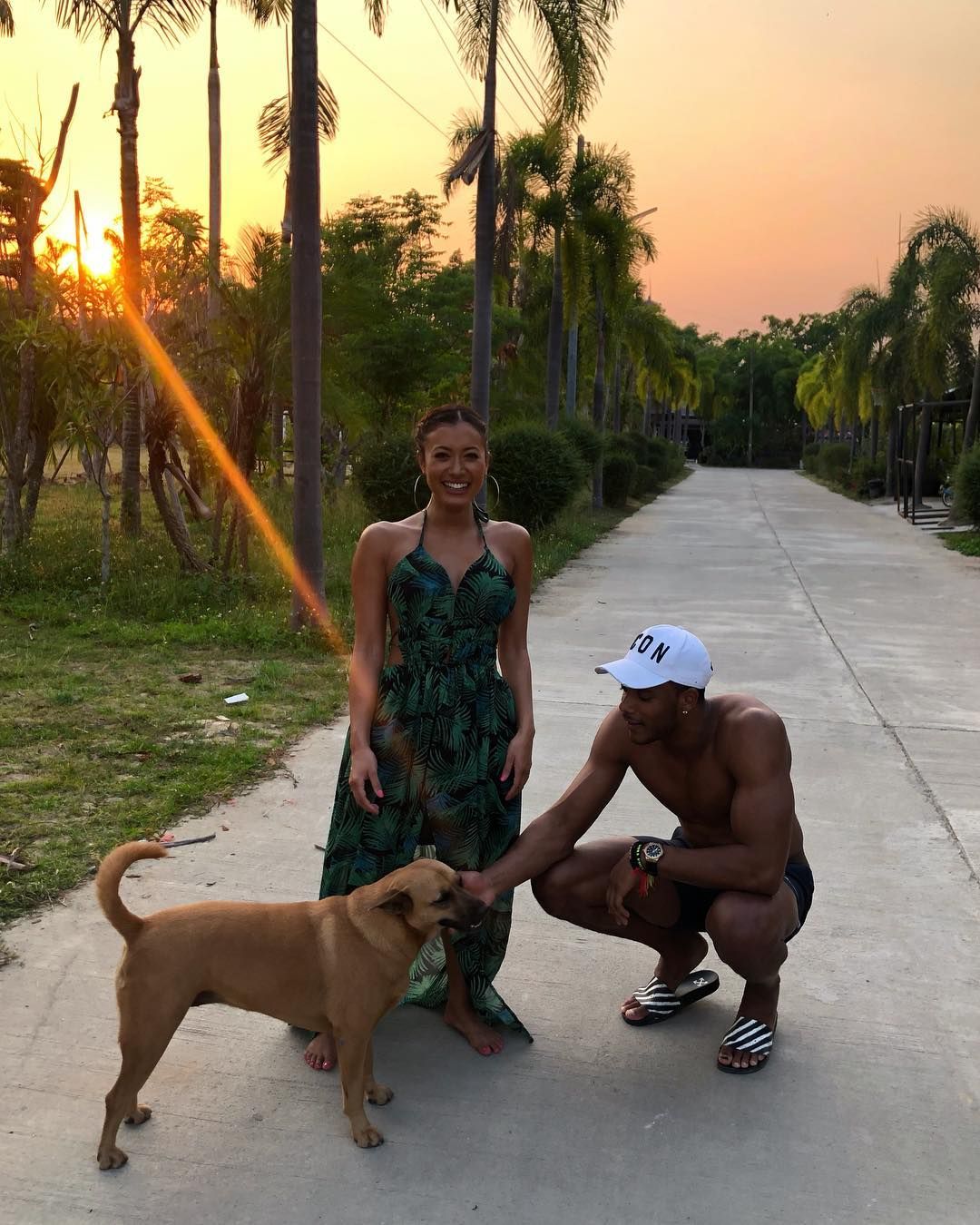 Image may contain: Kaz and Theo, Theo Campbell, Kazimir Crossley, Kaz Crossley, Love Island, dating, girlfriend, boyfriend,Sidewalk, Pavement, Back, Summer, Path, Footwear, Shoe, Palm Tree, Arecaceae, Plant, Tree, Shorts, Apparel, Clothing, Dog, Canine, Animal, Pet, Mammal, Human, Person