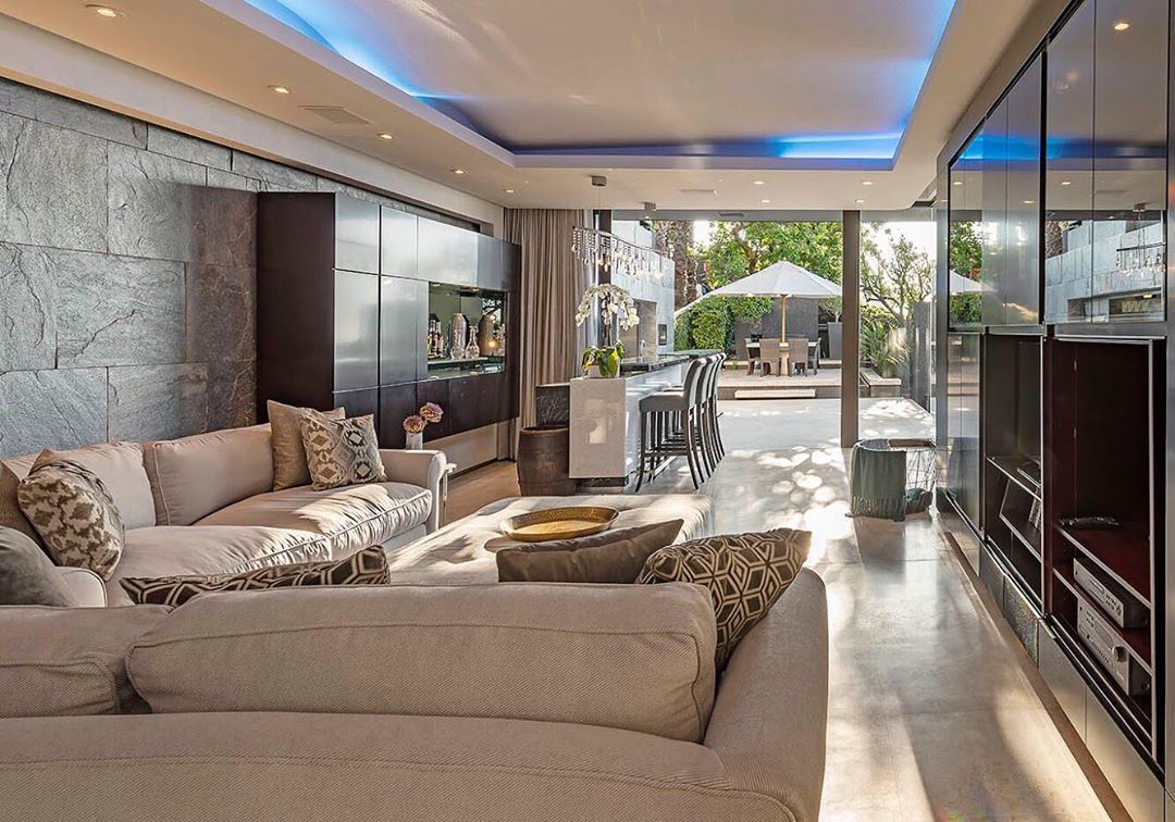 Image may contain: Moondance Villa, Cape Town, Made in Chelsea, South Africa, Table, Flooring, Rug, Lobby, Couch, Interior Design, Furniture, Living Room, Indoors, Room, Housing, Building