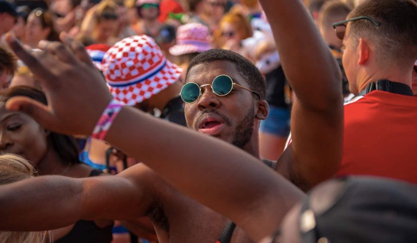 Image may contain: Finger, Festival, People, Glasses, Sunglasses, Accessory, Accessories, Audience, Person, Crowd, Human