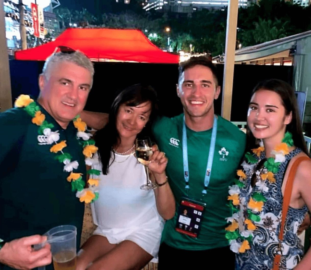 Image may contain: Love Island parents, Love Island, mum, dad, Greg, Lauren O'Shea, Niall, sister, Accessories, Sunglasses, Accessory, Lighting, Human, Flower Arrangement, Person, Flower, Blossom, Lei, Plant, Ornament