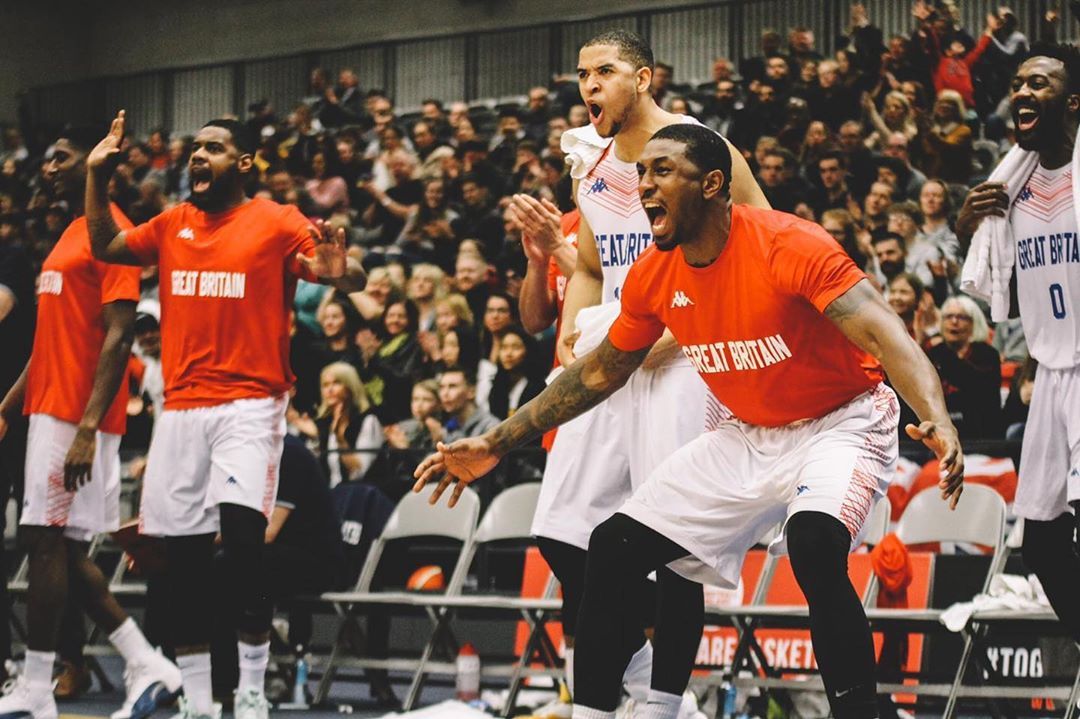 Image may contain: Ovie Soko net worth, Ovie, Love Island, net worth, earnings, money, team, basketball, salary, Ovie Soko, how much, Building, Outdoors, Team, Team Sport, Sport, Sports, Sphere, Shorts, People, Shoe, Footwear, Clothing, Apparel, Audience, Crowd, Person, Human