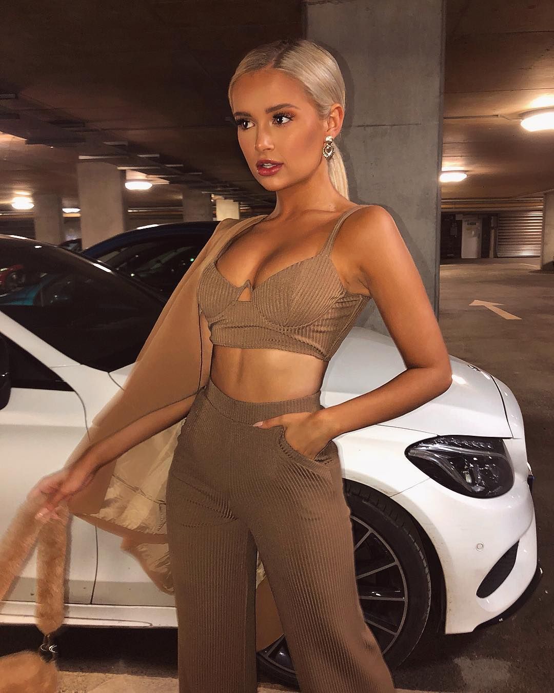 Image may contain: Car Wheel, Evening Dress, Fashion, Robe, Gown, Car, Transportation, Automobile, Vehicle, Alloy Wheel, Human, Person, Wheel, Machine, Spoke, Clothing, Apparel, Tire