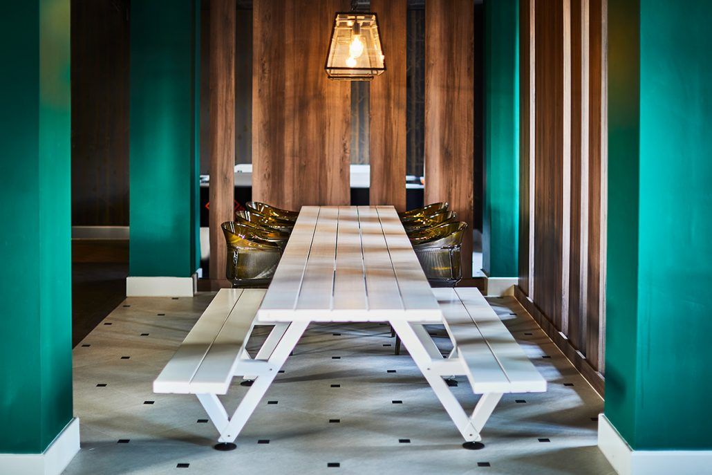 Image may contain: Dining Table, Table, Lobby, Hardwood, Plywood, Interior Design, Floor, Indoors, Room, Flooring, Wood, Furniture, Lighting