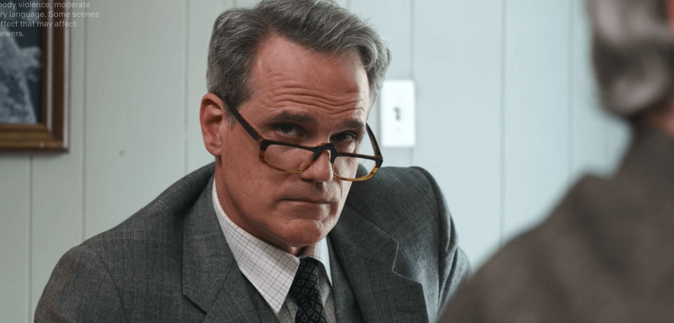 Image may contain: Stranger Things 3 new cast, Stranger Things 3, cast, new, Netflix, Michael Park, Editor, Hawkins Newspaper, Heather, dad, Head, Face, Executive, Human, Person, Tie, Apparel, Overcoat, Clothing, Coat, Suit, Accessory, Accessories, Glasses