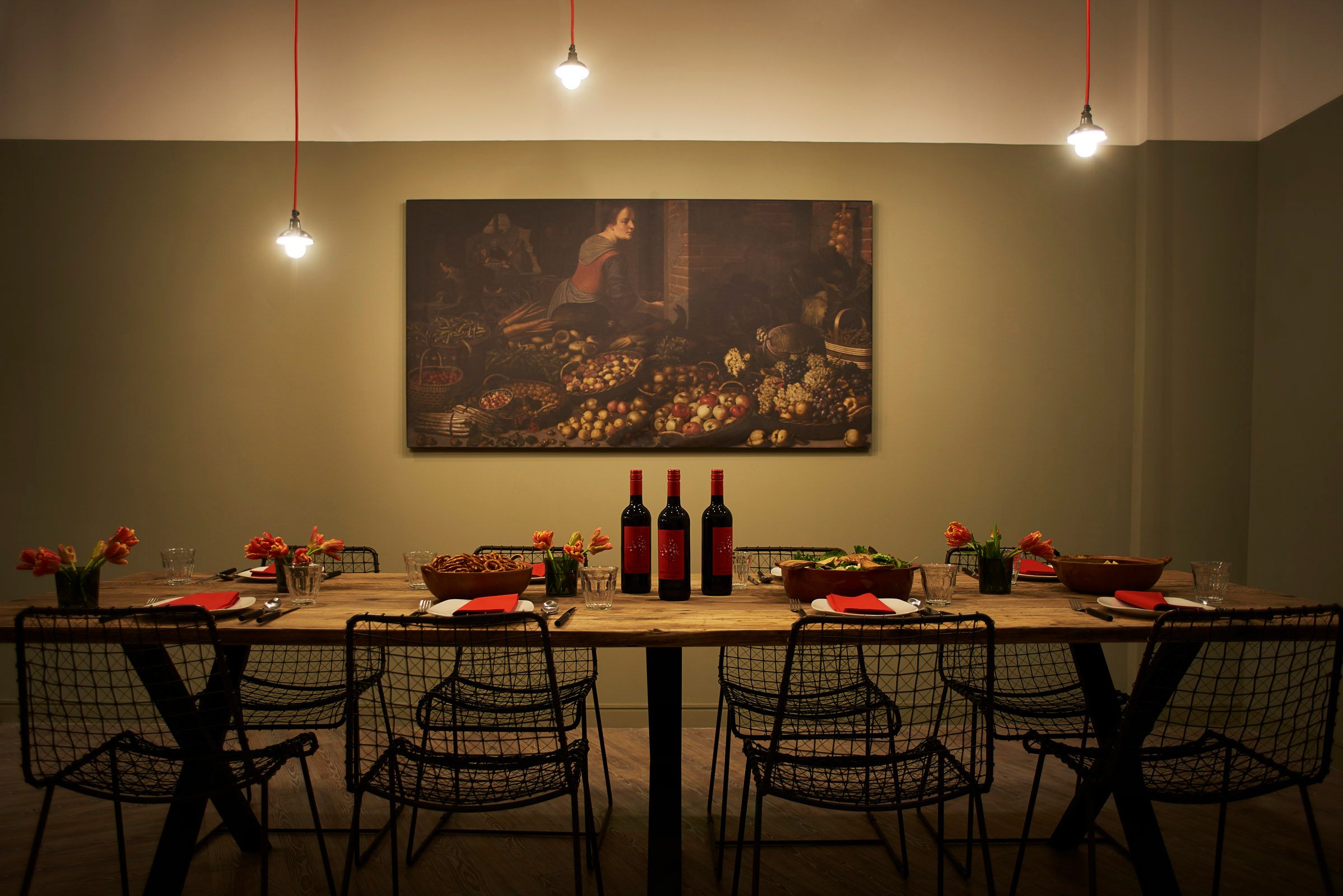 Image may contain: Indoors, Interior Design, Dining Table, Table, Wood, Wine, Bottle, Lighting, Restaurant, Alcohol, Drink, Beverage, Chair, Furniture