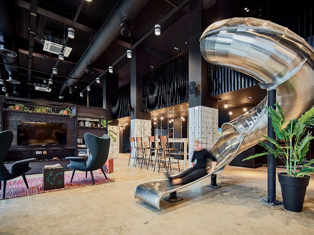 Image may contain: Interior Design, Indoors, Building, Housing, Handrail, Banister, Person, Human, Chair, Furniture
