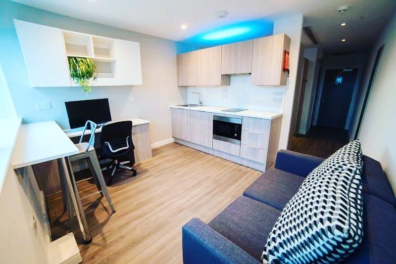 Image may contain: Living Room, Chair, Rug, Housing, Building, Table, Room, Interior Design, Furniture, Indoors