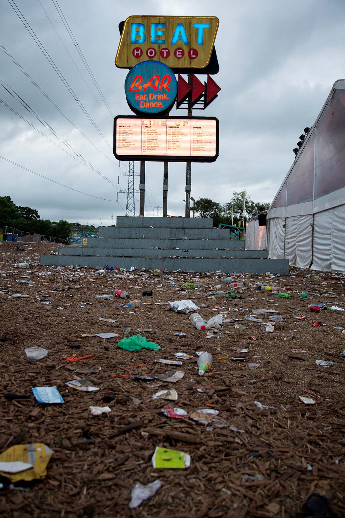 Image may contain: Rug, Billboard, Trash, Advertisement, Pollution
