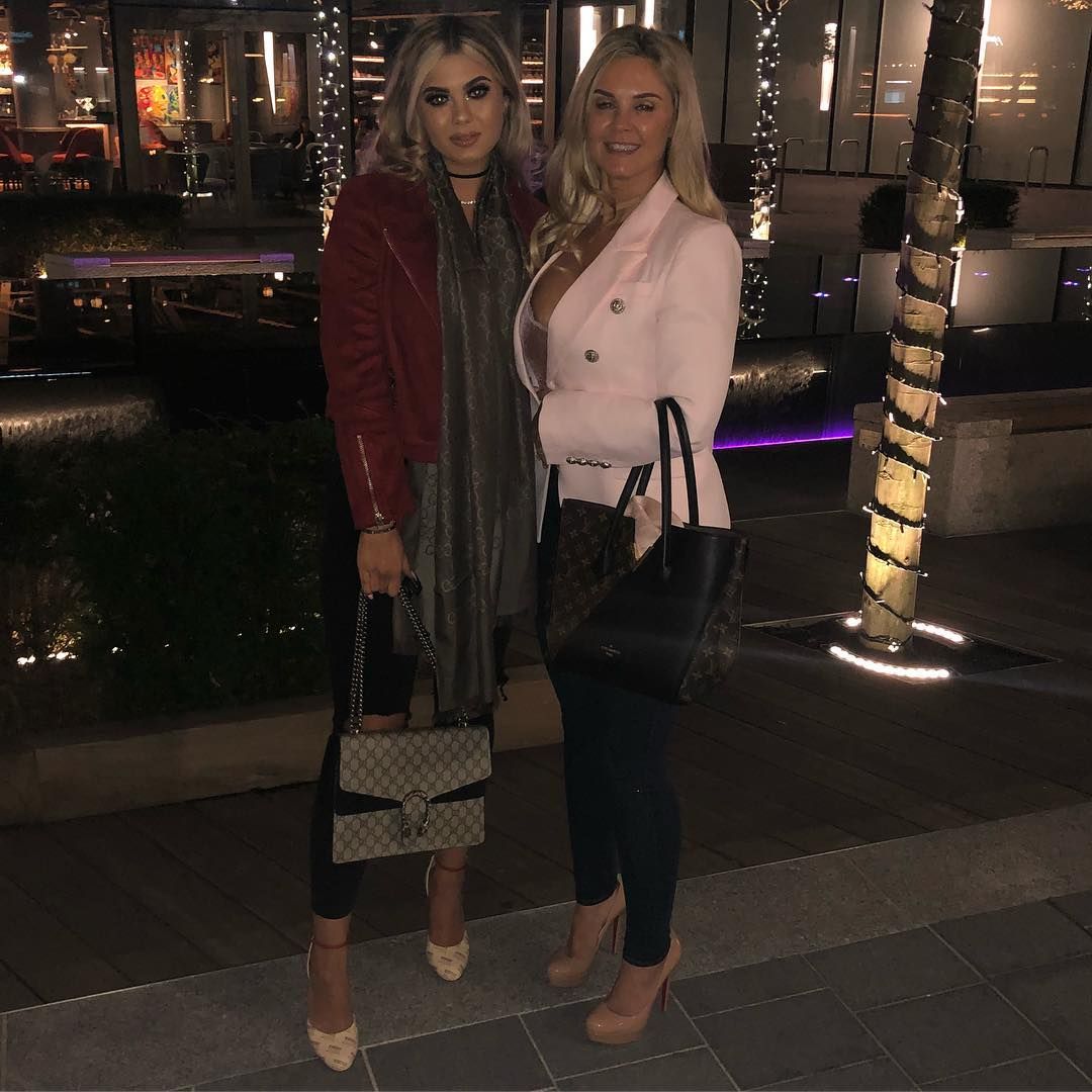 Image may contain: Love Island parents, Love Island, mum, dad, Belle, Tamer Hassan, Karen Hassan, Sleeve, Handbag, Bag, Accessories, Accessory, Shoe, Footwear, Coat, Overcoat, Person, Human, Clothing, Apparel