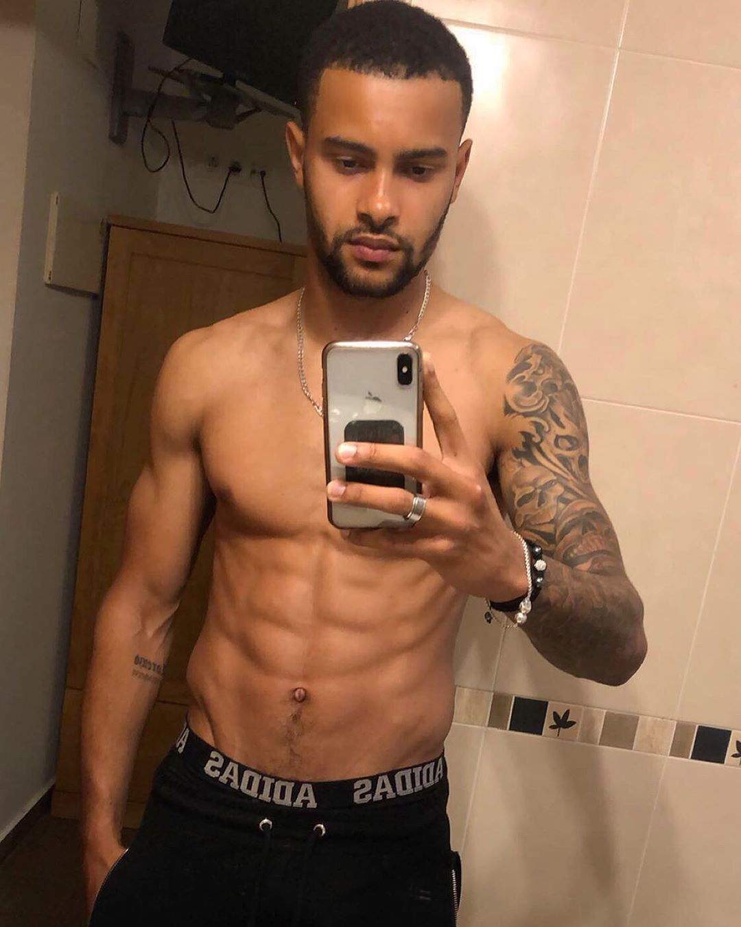 Image may contain: Casa Amor transformations, Casa Amor, Dennon Lewis, Love Island, Instagram, before, after, Tattoo, Face, Cell Phone, Phone, Mobile Phone, Electronics, Man, Indoors, Interior Design, Human, Person, Skin