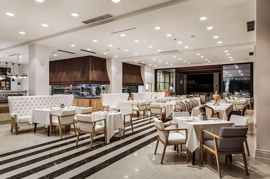 Image may contain: Abaton Island resort, Celebs Go Dating, final, Abaton Island Resort & Spa, Crete, Greece, Abaton, hotel, Island, bar, cost, Cafe, Indoors, Dining Table, Table, Rug, Cafeteria, Chair, Furniture, Restaurant