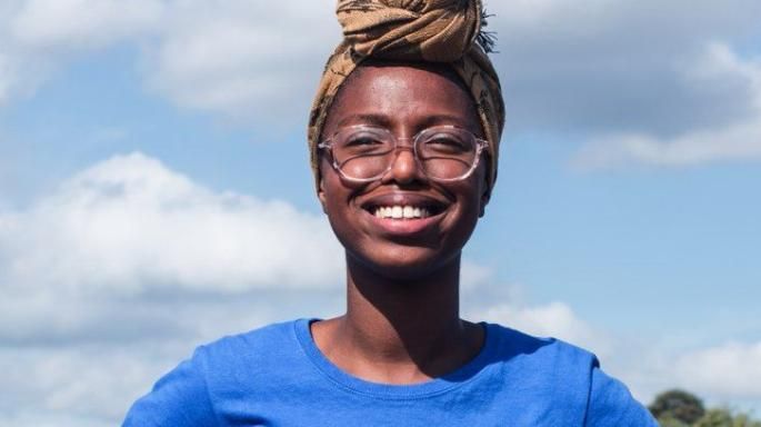 Image may contain: Joy Morgan, Female, Headband, Hat, Portrait, Photography, Photo, Head, Laughing, Clothing, Apparel, Person, Human, Smile, Face