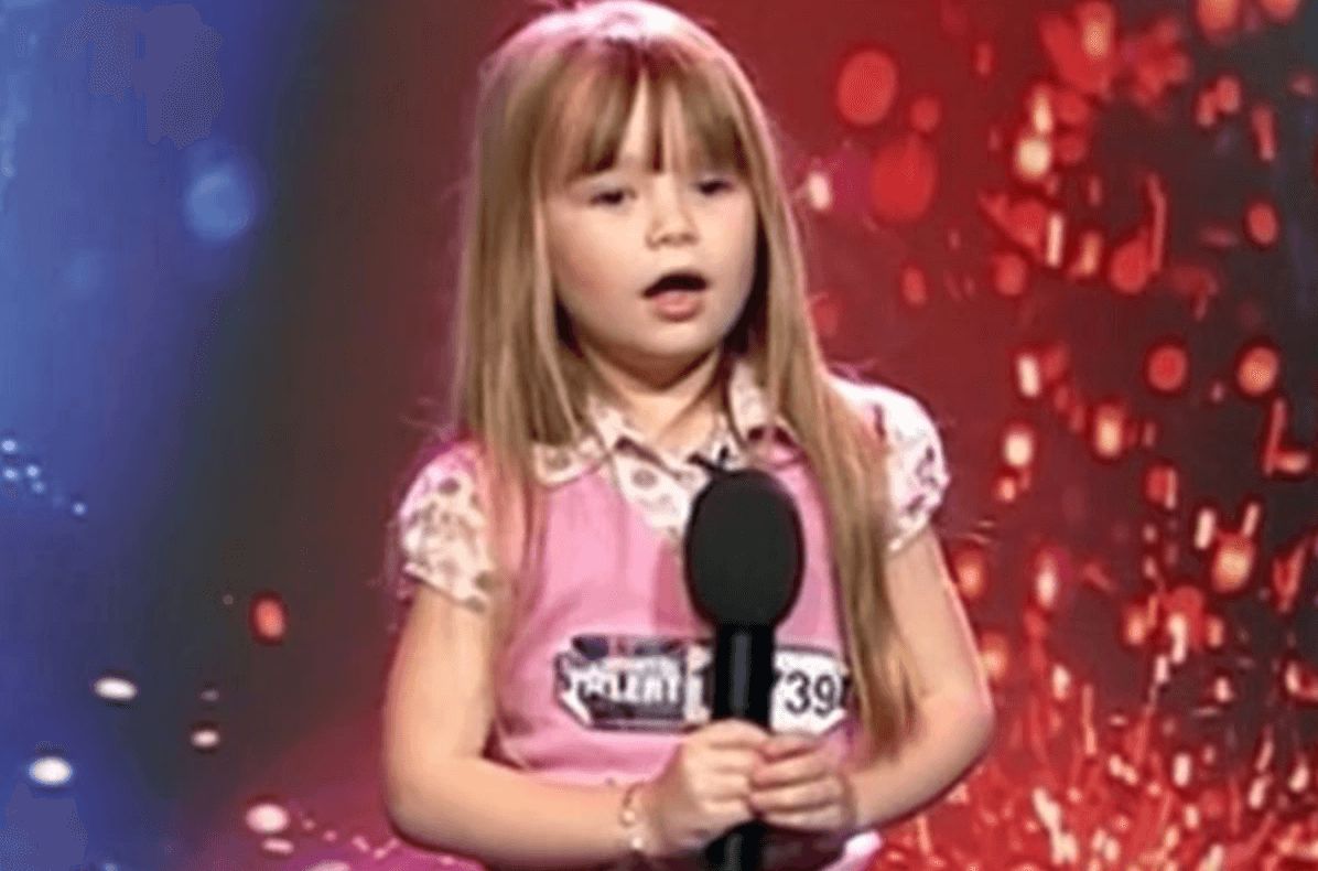 Image may contain: Connie Talbot, Britain's Got Talent, audition, first, performance, 2007, BGT, then, now, before, after, old, young, Over The Rainbow, series one, ITV, Leisure Activities, Karaoke, Duet, Smile, Clothing, Apparel, Face, Woman, Blonde, Child, Teen, Girl, Kid, Female, Lighting, Human, Person