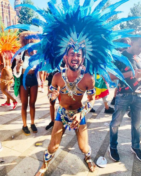 Image may contain: Parade, Carnival, Crowd, Human, Person, Apparel, Shoe, Clothing, Footwear