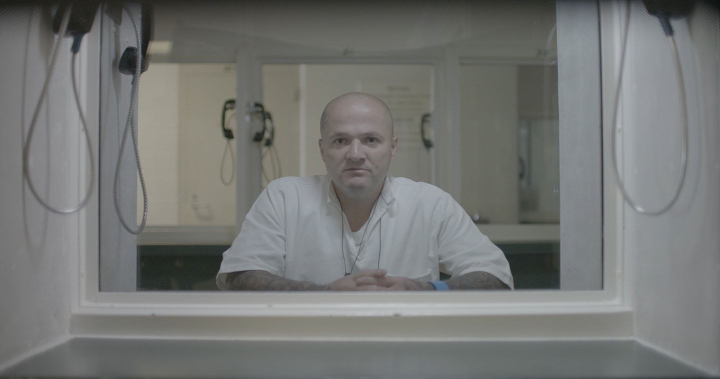 Image may contain: I Am a Killer, Justin Dickens, Netflix, Texas, prison, inmate, death row, true, real, life, story, crime, Shelf, Flooring, Plywood, Wood, Person, Human