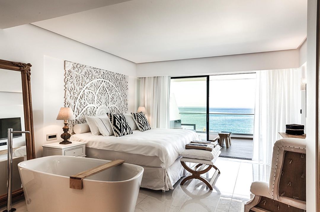 Image may contain: Abaton Island resort, Celebs Go Dating, final, Abaton Island Resort & Spa, Crete, Greece, Abaton, hotel, Island, bedroom, ocean, view, inside, cost, Table Lamp, Lamp, Bedroom, Room, Bed, Furniture, Interior Design, Indoors, Building, Housing