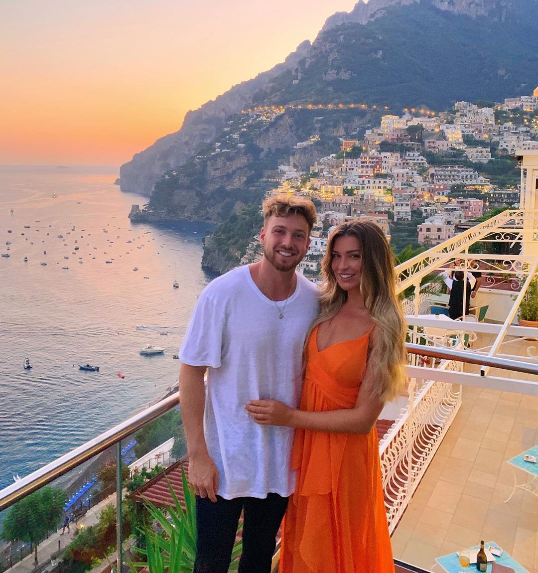 Image may contain: Sam and Zara Made in Chelsea, Sam Thompson, Zara McDermott, Made in Chelsea, new, series, 18, cast, Love Island, relationship, together, Vacation, Evening Dress, Gown, Apparel, Clothing, Fashion, Robe, Railing, Balcony, Person, Human
