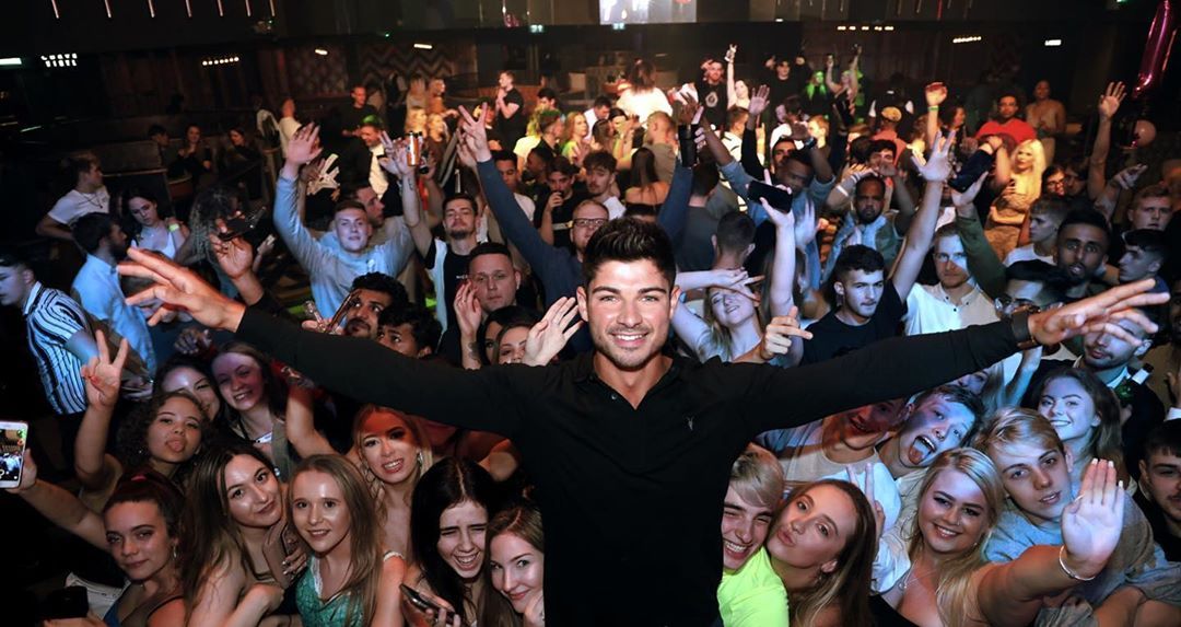Image may contain:  Love Island 2019 contestants, Love Island, 2019, now, job, Instagram, updates, news, latest, series five, Anton Danyluk, Accessories, Accessory, Sunglasses, Disco, Face, Audience, Crowd, Club, Night Club, Person, Human, Party, Night Life