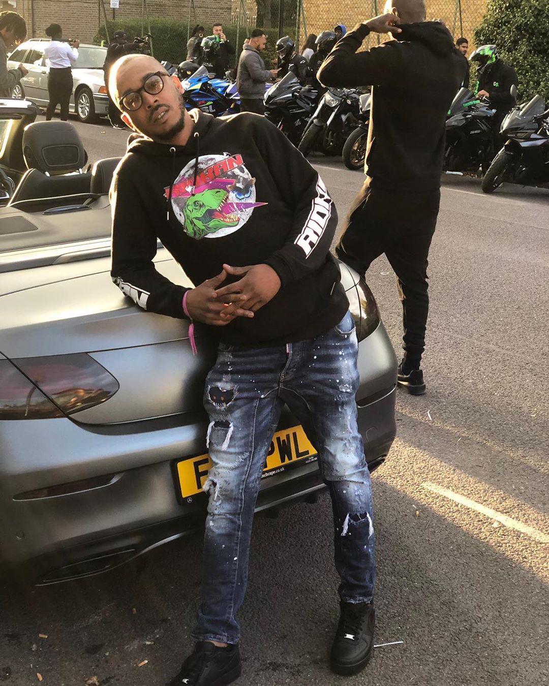 Image may contain: Top Boy cast, Top Boy, season 3, Netflix, Shone Romulus, Dris,  Car Wheel, Car, Automobile, Transportation, Vehicle, Motorcycle, Spoke, Alloy Wheel, Machine, Wheel, Helmet, Crash Helmet, Tire, Pants, Footwear, Shoe, Sunglasses, Accessory, Accessories, Person, Human, Apparel, Clothing