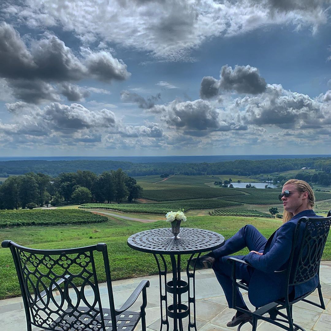 Image may contain: Cumulus, Sitting, Cloud, Sky, Flagstone, Dining Table, Plant, Grass, Weather, Patio, Table, Tabletop, Nature, Outdoors, Chair, Furniture, Person, Human