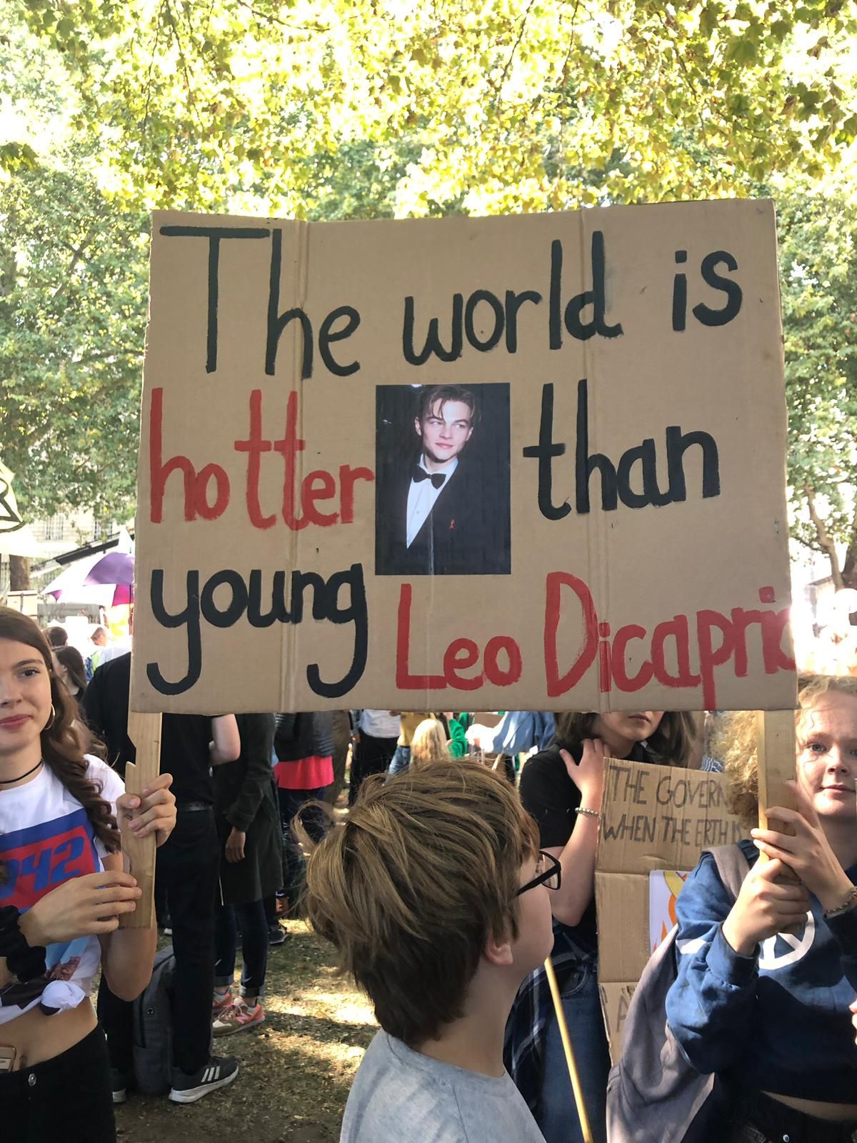 Image may contain: Footwear, Apparel, Shoe, Clothing, Crowd, Human, Person, Banner, Text