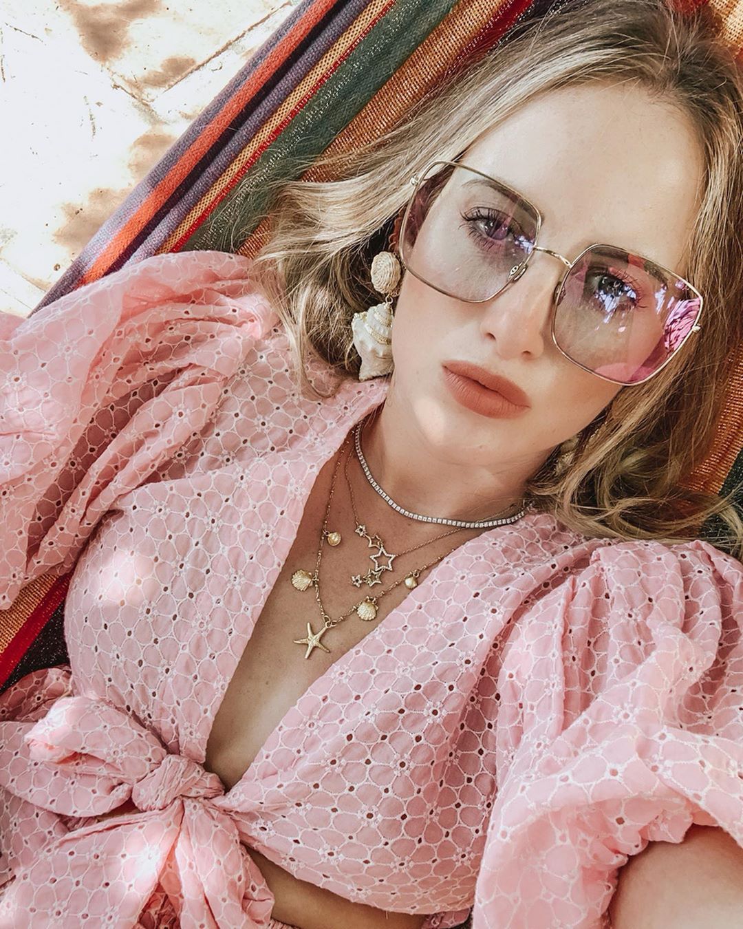 Image may contain: Made in Chelsea heirs, Made in Chelsea, MIC, family, fortunes, money, business, company, worth, cash, inheritance, Rosie Fortescue, Hammock, Person, Human, Sunglasses, Accessories, Accessory, Furniture