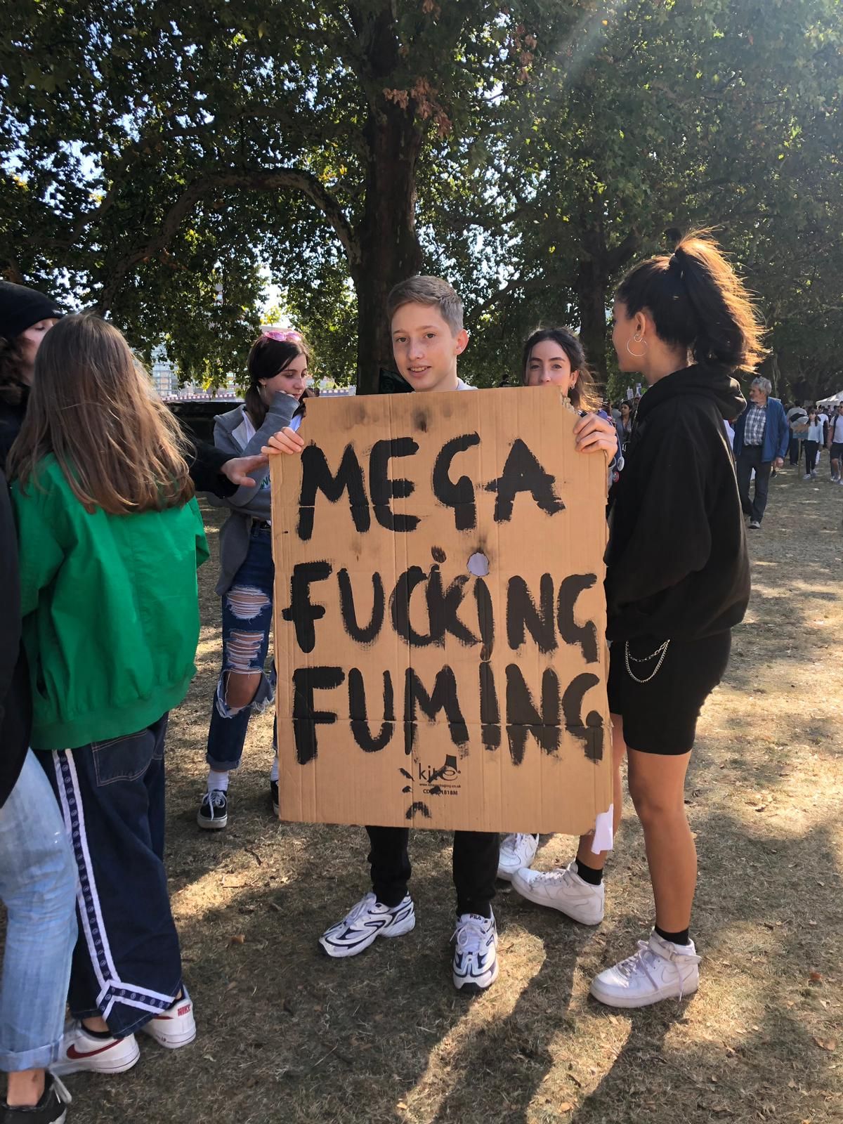 Image may contain: Label, Crowd, Word, Banner, Text, Person, Human, Apparel, Footwear, Shoe, Clothing