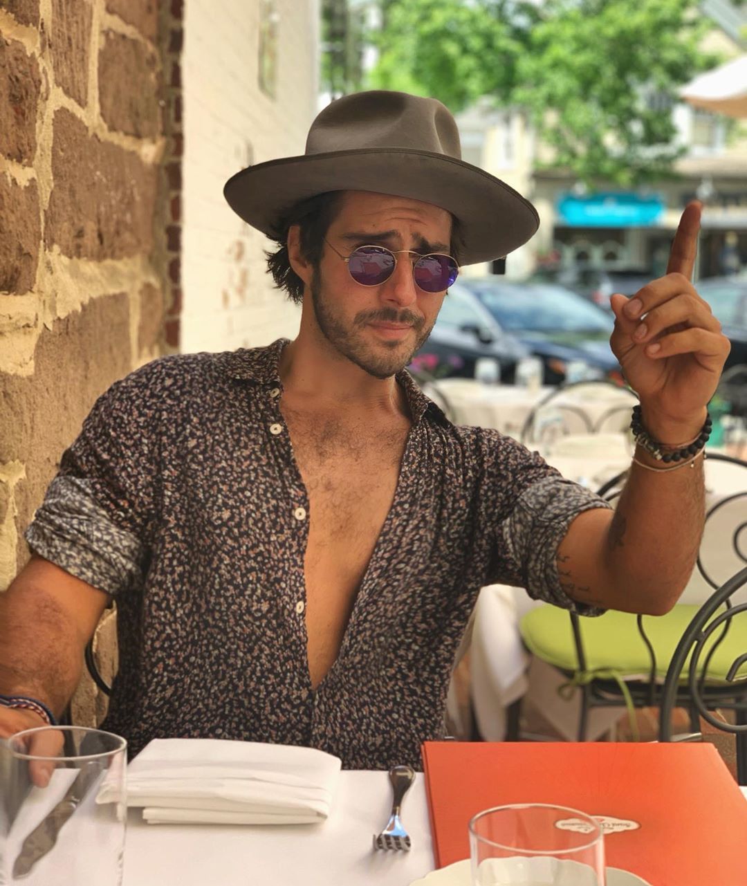 Image may contain: Made in Chelsea heirs, Made in Chelsea, MIC, family, fortunes, money, business, company, worth, cash, inheritance, Alik Alfus, Restaurant, Finger, Accessories, Sunglasses, Accessory, Clothing, Apparel, Hat, Human, Person