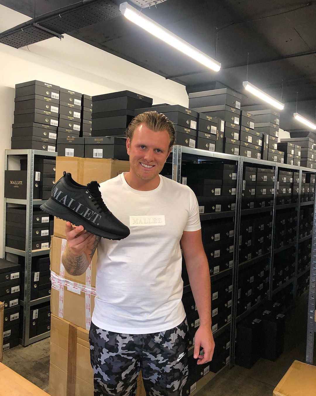 Image may contain: reality TV rich list, UK, reality TV, net worth, earnings, money, salary, rich, worth, Tommy Mallet, TOWIE, Shop, Shelf, Footwear, Shoe, Hat, Human, Person, Apparel, Clothing