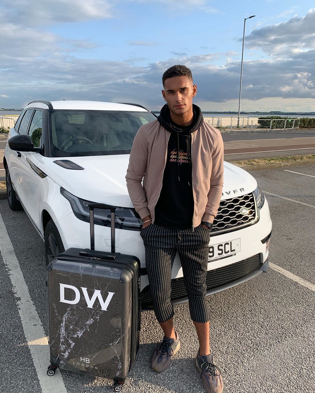 Image may contain:  Love Island 2019 contestants, Love Island, 2019, now, job, Instagram, updates, news, latest, series five, Danny Williams, Sleeve, Car Wheel, Wheel, Machine, Pedestrian, Car, Automobile, Transportation, Vehicle, Tire, Road, Clothing, Apparel, Person, Human