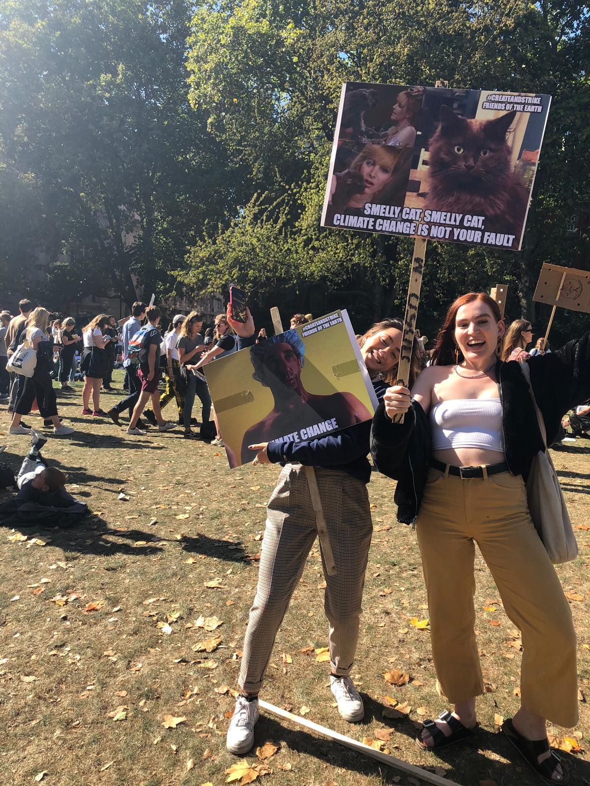 Image may contain: Transportation, Offroad, Vehicle, Text, Footwear, Apparel, Shoe, Clothing, Pet, Mammal, Cat, Animal, Protest, Parade, Crowd, Human, Person