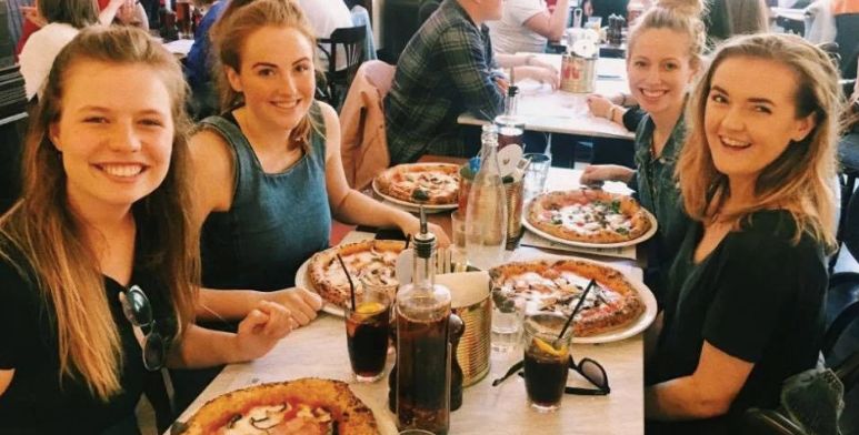 Image may contain: Face, Eating, Dating, Dish, People, Pizza, Dining Table, Dinner, Supper, Table, Furniture, Food, Meal, Restaurant, Person, Human