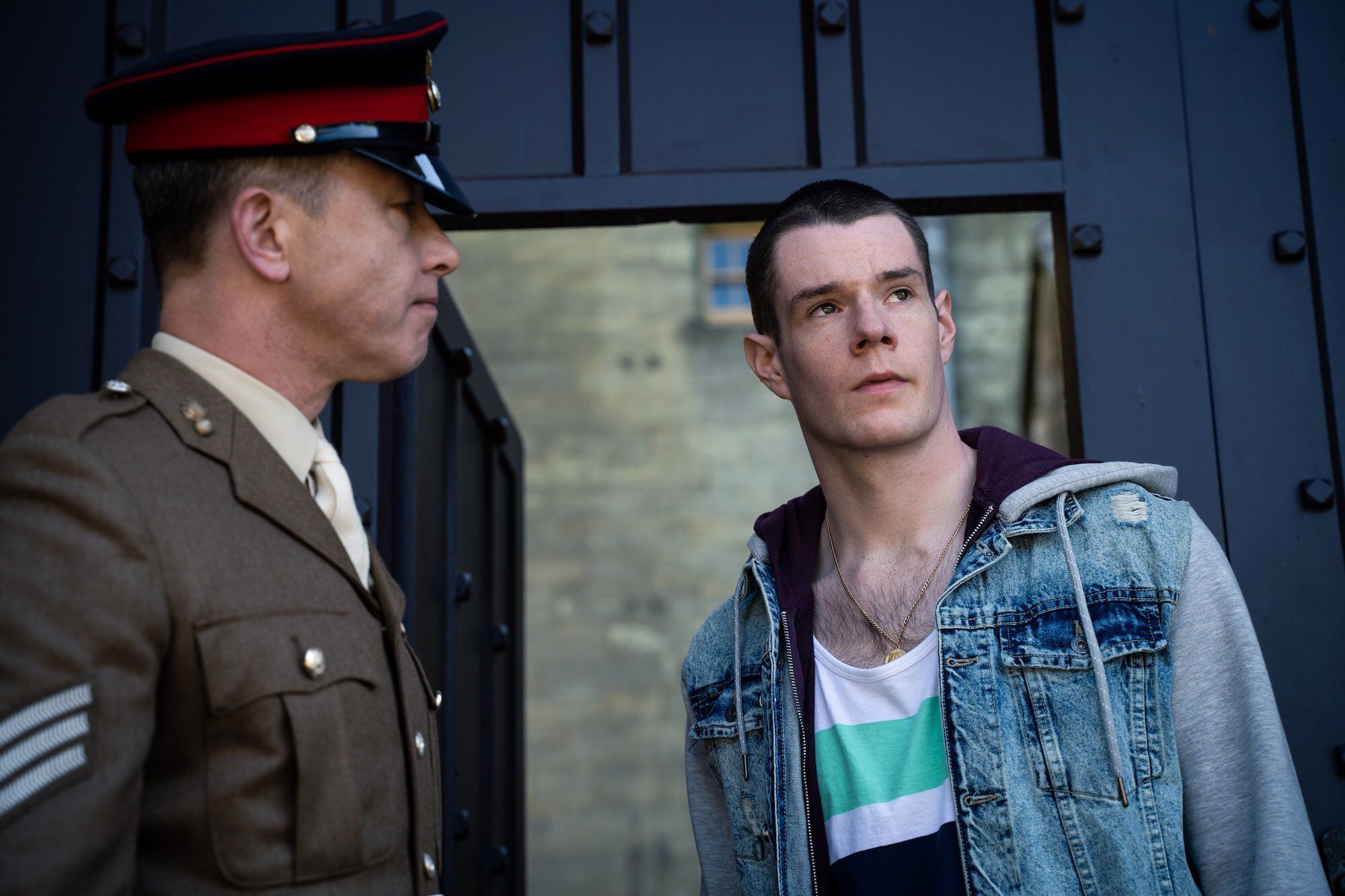 Image may contain: Hat, Man, Captain, Apparel, Coat, Overcoat, Suit, Clothing, Military Uniform, Officer, Military, Human, Person, sex education season 2 preview, netflix, otis milburn